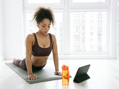 Close-up of a yoga mat and a water bottle in a serene setting.